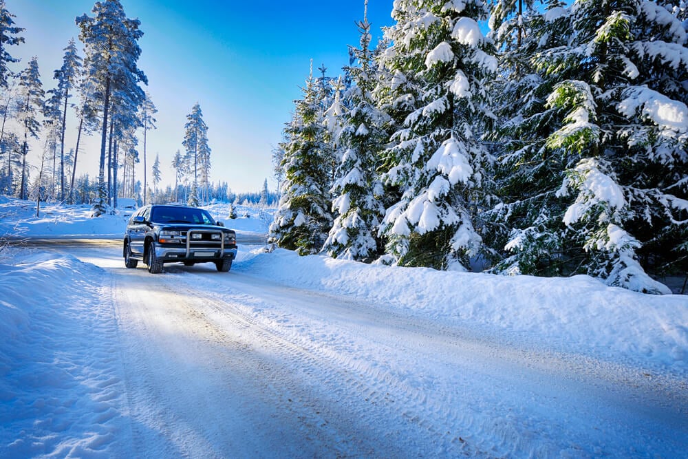 Winter road with car